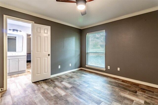 1809 Faulkner Dr, Rowlett, TX 75088 - unfurnished bedroom featuring baseboards, ornamental molding, a ceiling fan, and wood finished floors
