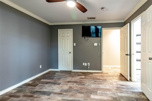 1809 Faulkner Dr, Rowlett, TX 75088 - unfurnished bedroom featuring visible vents, baseboards, crown molding, and wood finished floors