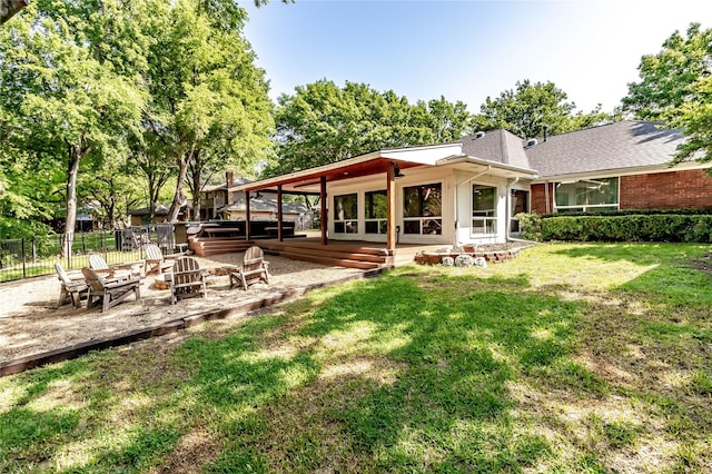 1809 Faulkner Dr, Rowlett, TX 75088 - back of house featuring fence, brick siding, a jacuzzi, a patio area, and a yard