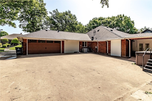 1809 Faulkner Dr, Rowlett, TX 75088 - ranch-style house with french doors, a garage, a hot tub, brick siding, and concrete driveway