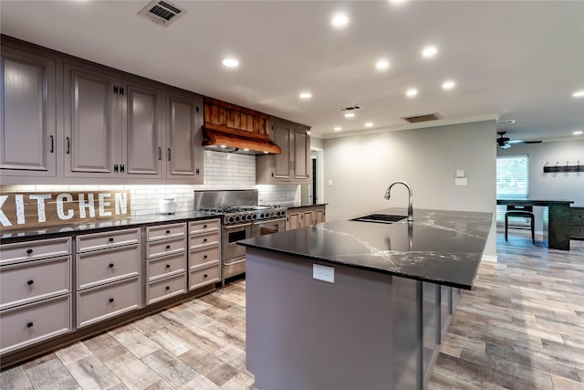 1809 Faulkner Dr, Rowlett, TX 75088 - kitchen with visible vents, a sink, custom range hood, and range with two ovens