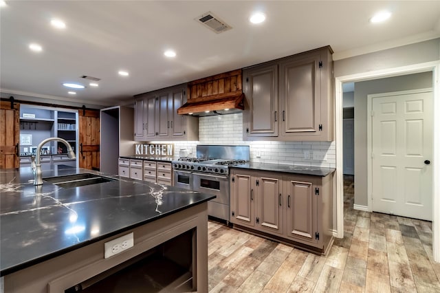 1809 Faulkner Dr, Rowlett, TX 75088 - kitchen with visible vents, crown molding, range with two ovens, a sink, and custom range hood