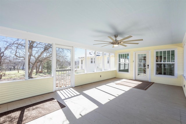 unfurnished sunroom with a ceiling fan