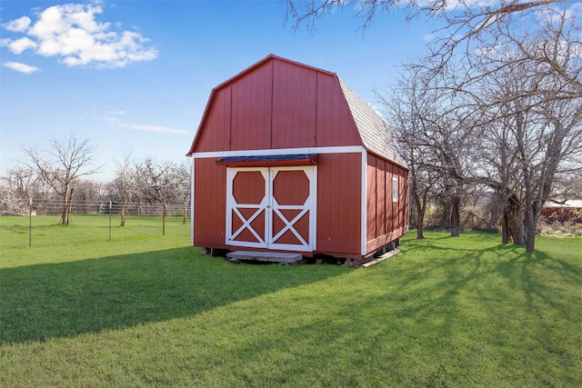 view of outdoor structure featuring an outbuilding and fence