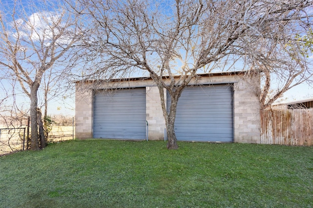 detached garage featuring fence