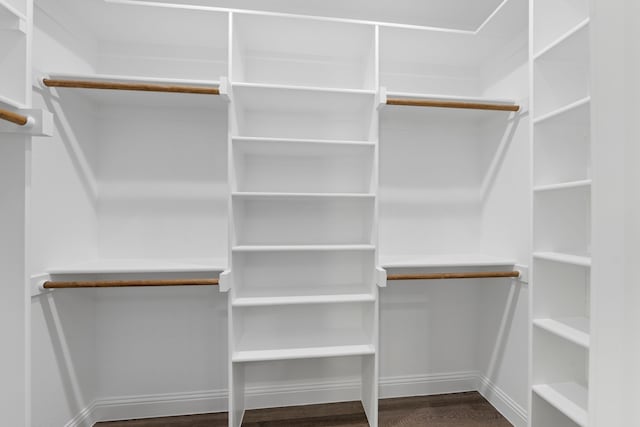 walk in closet with wood finished floors