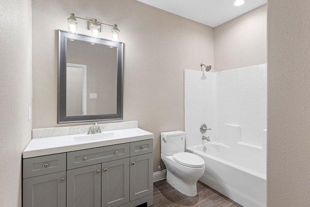 full bathroom with vanity, toilet, wood finished floors, and shower / washtub combination