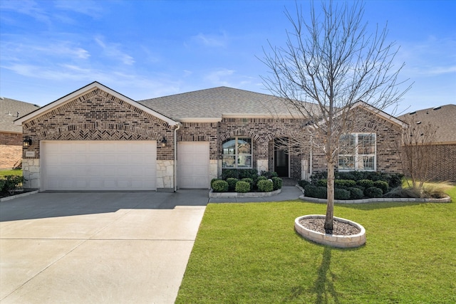 french country style house featuring brick siding, a front lawn, roof with shingles, a garage, and driveway