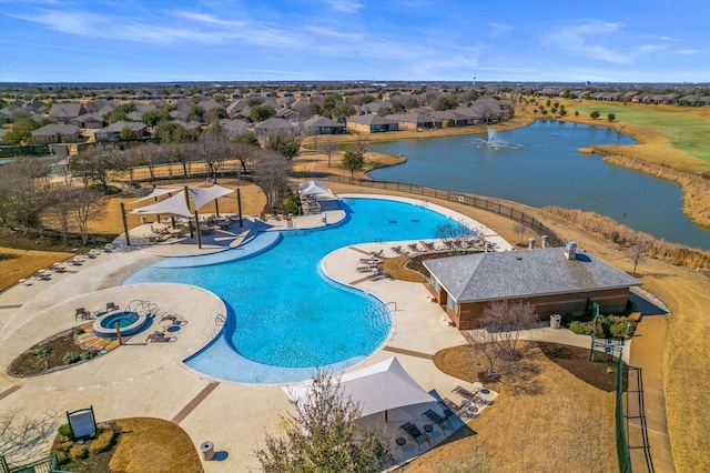 pool featuring a patio and a water view