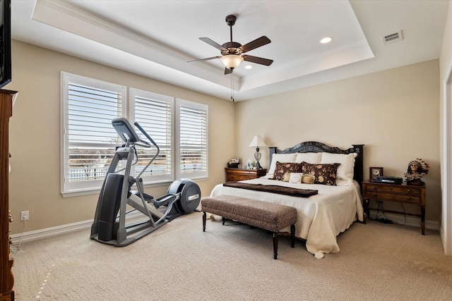 bedroom featuring visible vents, baseboards, carpet, a raised ceiling, and a ceiling fan