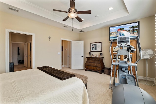 bedroom featuring visible vents, a raised ceiling, ornamental molding, and carpet flooring