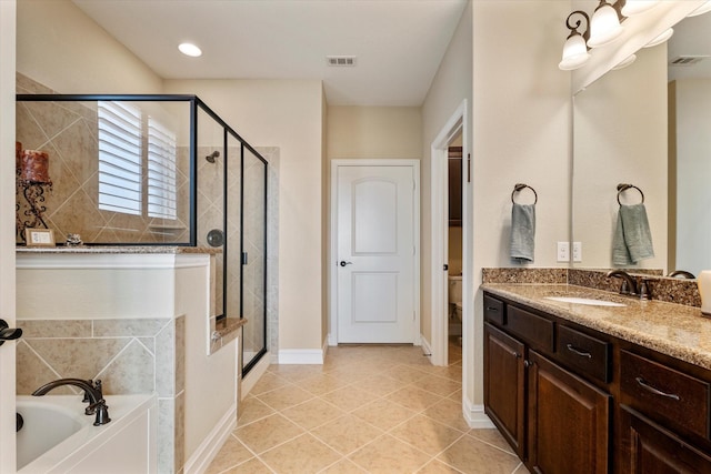 bathroom featuring a shower stall, a bath, and visible vents