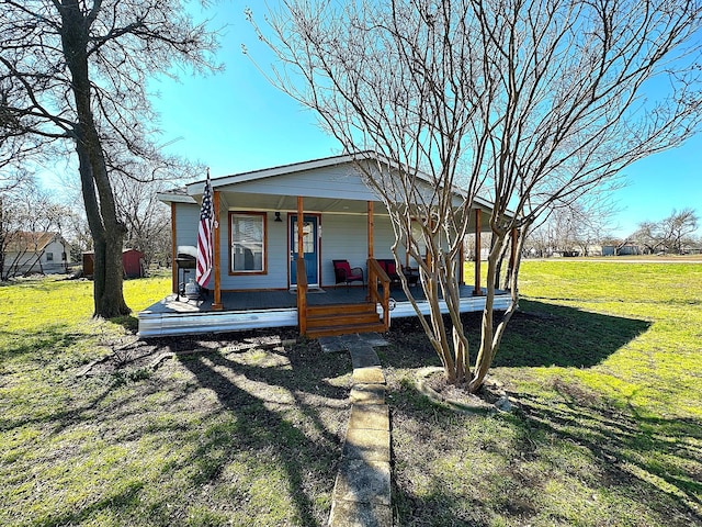 view of front facade with covered porch and a front yard