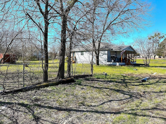 view of yard featuring a porch and fence