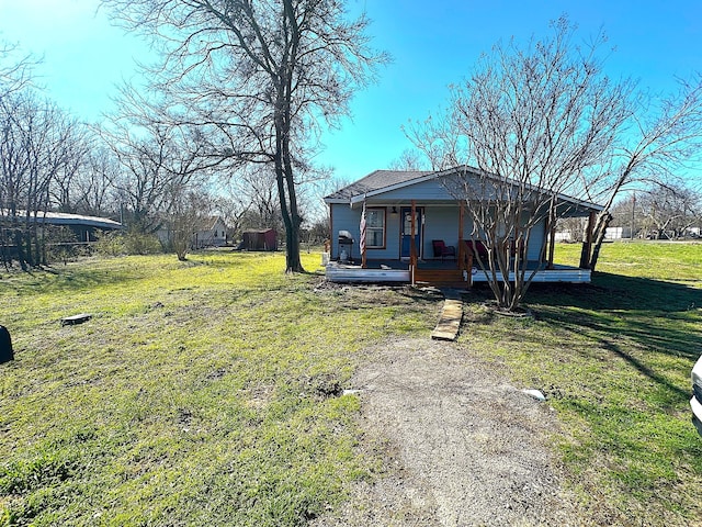 view of front of property with a porch, driveway, and a front yard