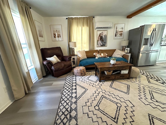 living room with beam ceiling and a wall mounted AC