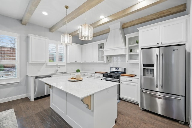 kitchen with premium range hood, a sink, appliances with stainless steel finishes, white cabinets, and a chandelier