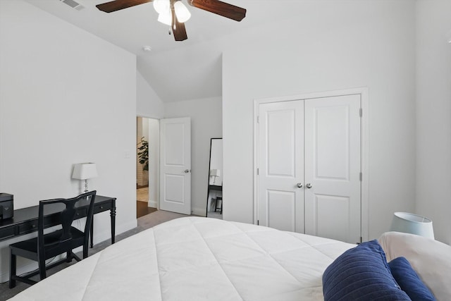 bedroom featuring a closet, baseboards, a ceiling fan, and lofted ceiling