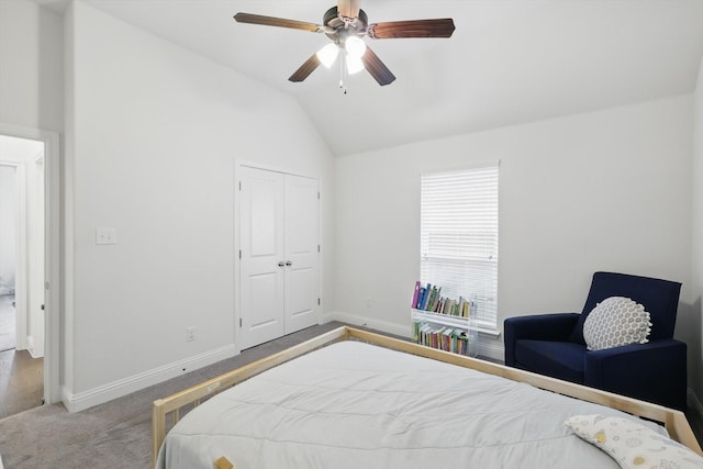 carpeted bedroom featuring a closet, baseboards, ceiling fan, and vaulted ceiling