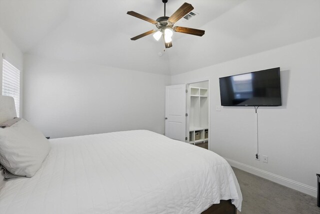 bedroom with a ceiling fan, baseboards, visible vents, carpet floors, and lofted ceiling