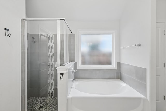 full bathroom featuring a shower stall and a bath