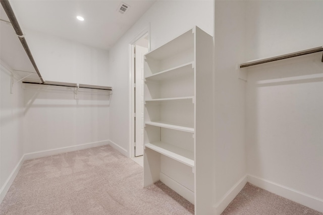 spacious closet with visible vents and carpet