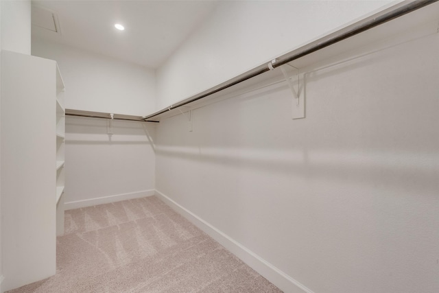 walk in closet with carpet