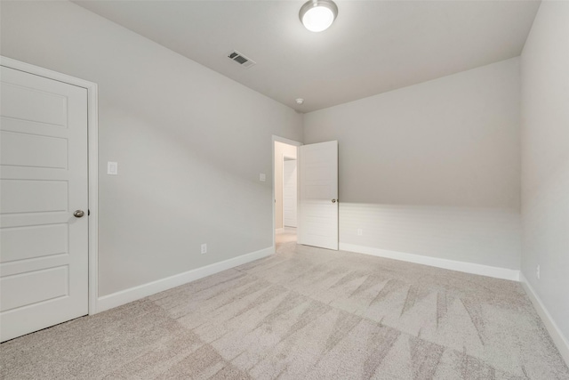 unfurnished room featuring visible vents, baseboards, and carpet