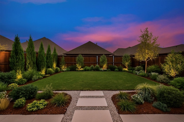 view of front of property featuring a front yard and a fenced backyard
