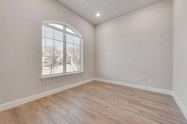 spare room featuring recessed lighting, baseboards, and light wood-style floors