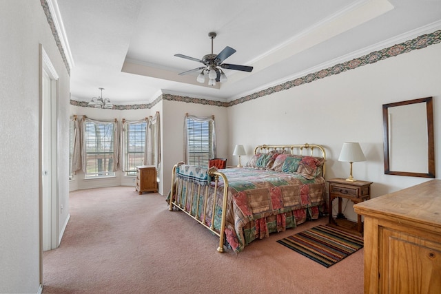 bedroom featuring ceiling fan with notable chandelier, a raised ceiling, crown molding, and light colored carpet