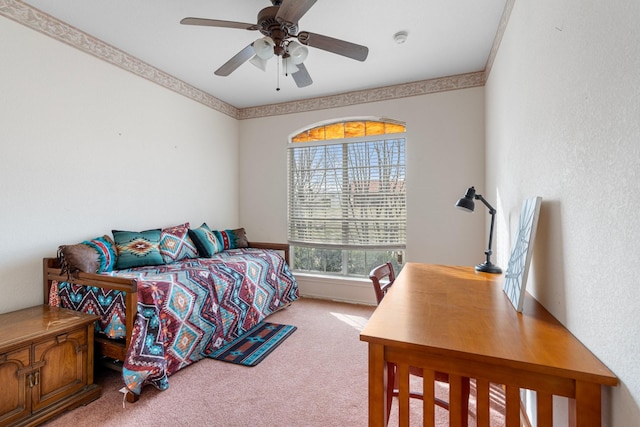 bedroom with light colored carpet, ceiling fan, and crown molding