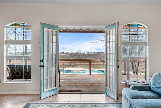 doorway to outside featuring plenty of natural light and tile patterned flooring