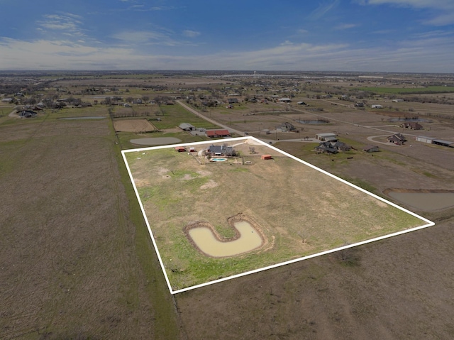 birds eye view of property with a rural view