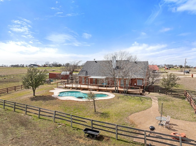 view of pool with a yard, a rural view, fence private yard, and a wooden deck