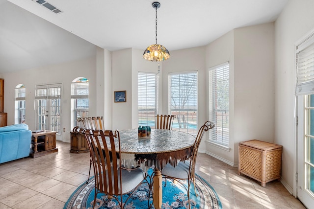 dining room with light tile patterned floors, visible vents, plenty of natural light, and baseboards