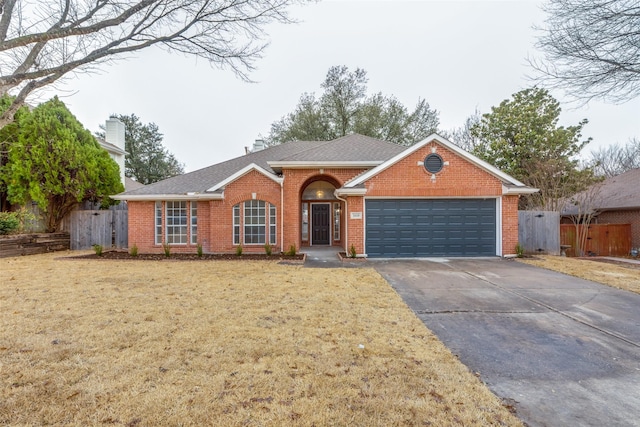 single story home with a front lawn, fence, concrete driveway, a garage, and brick siding