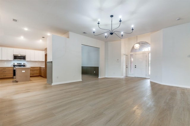 unfurnished living room with baseboards and light wood-style floors