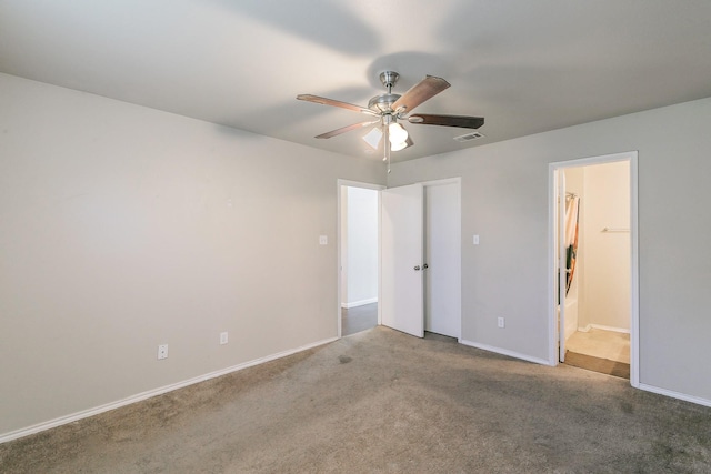 unfurnished bedroom featuring a ceiling fan, baseboards, carpet floors, and connected bathroom