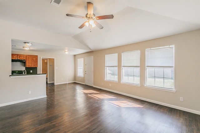 unfurnished living room with lofted ceiling, baseboards, visible vents, and dark wood-style flooring