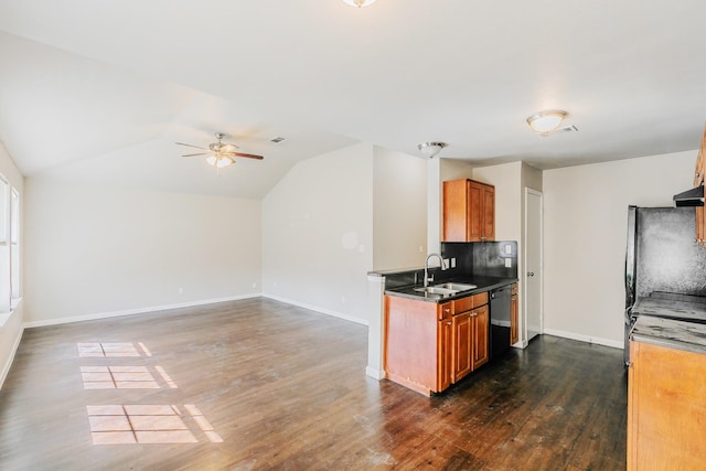 kitchen with lofted ceiling, dark wood-style flooring, ceiling fan, a sink, and brown cabinets