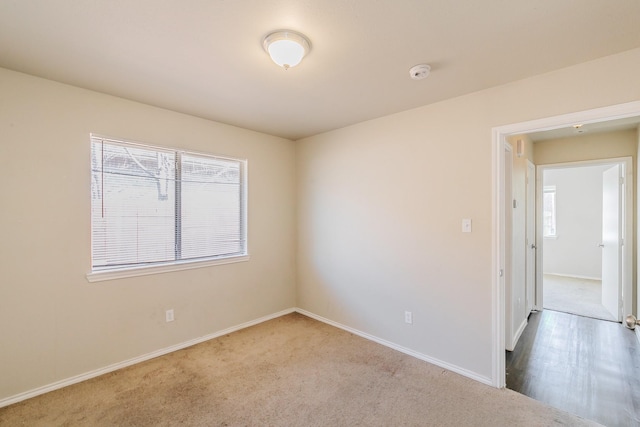 empty room with carpet and baseboards