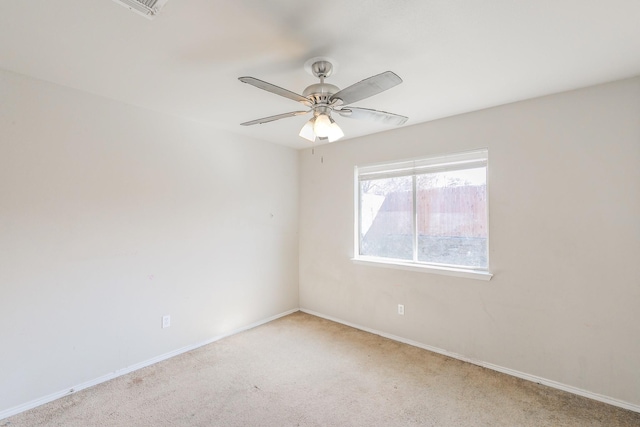 spare room featuring carpet flooring, a ceiling fan, and baseboards