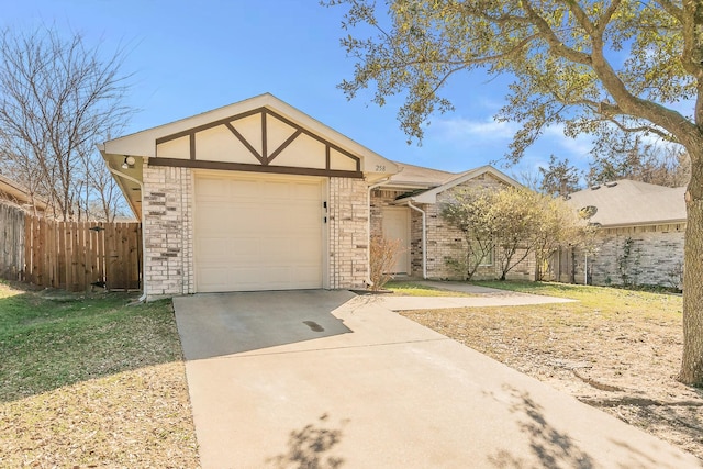 view of front facade featuring a garage, brick siding, concrete driveway, and fence