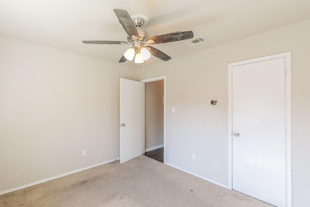 unfurnished room with ceiling fan, carpet, visible vents, and baseboards