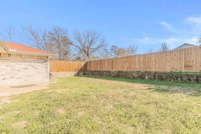 view of yard with a fenced backyard