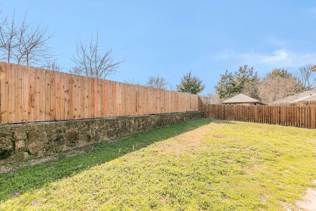 view of yard with a fenced backyard