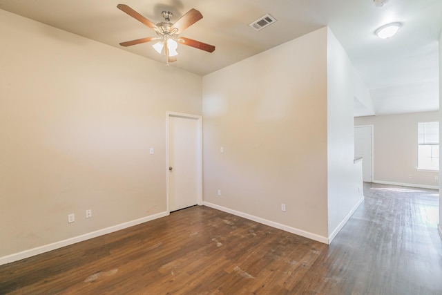 empty room with visible vents, ceiling fan, baseboards, and wood finished floors