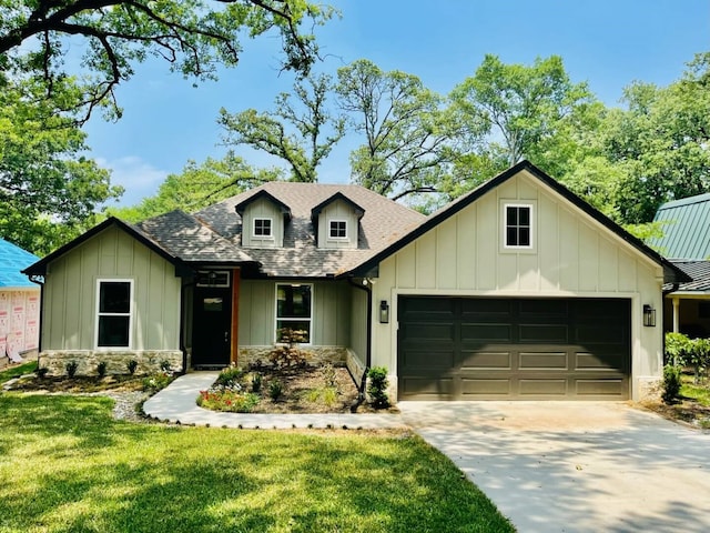 view of front of house featuring board and batten siding, a shingled roof, a front lawn, concrete driveway, and an attached garage