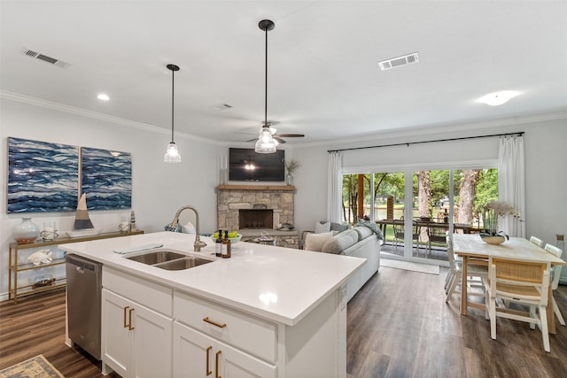 kitchen with a sink, visible vents, dishwasher, and ornamental molding